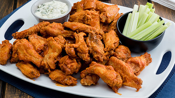Frank’s RedHot Original Buffalo Chicken Wings on a platter with celery and dip