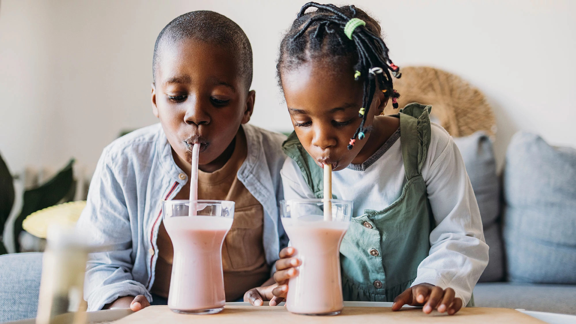 2 Kids Drinking Pink Smoothies